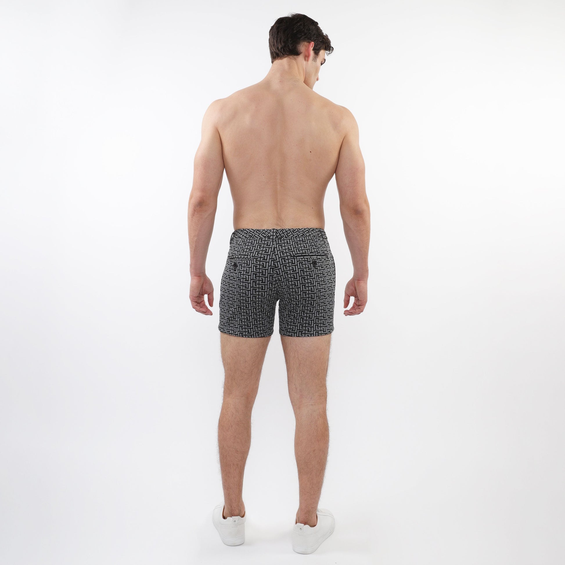 Black and white geometric patterned textured jacquard stretch knit chino swim trunks with zip pockets