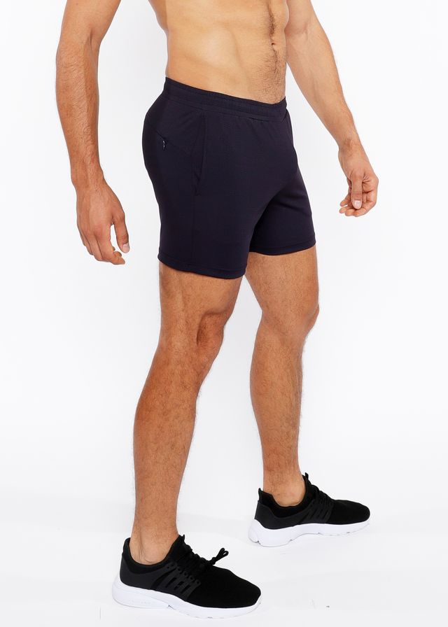 Black textured mesh stretch performance shorts with a sleek form-fitting design and subtle side pockets