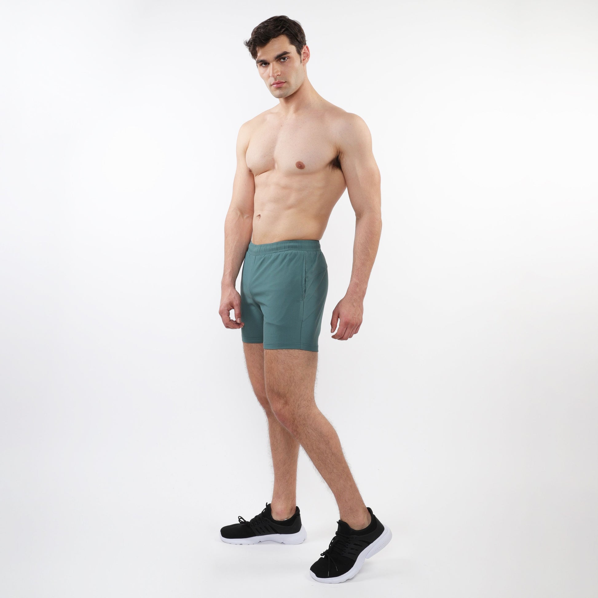 Teal textured mesh stretch performance shorts with sleek modern design and subtle side pockets for athletic use
