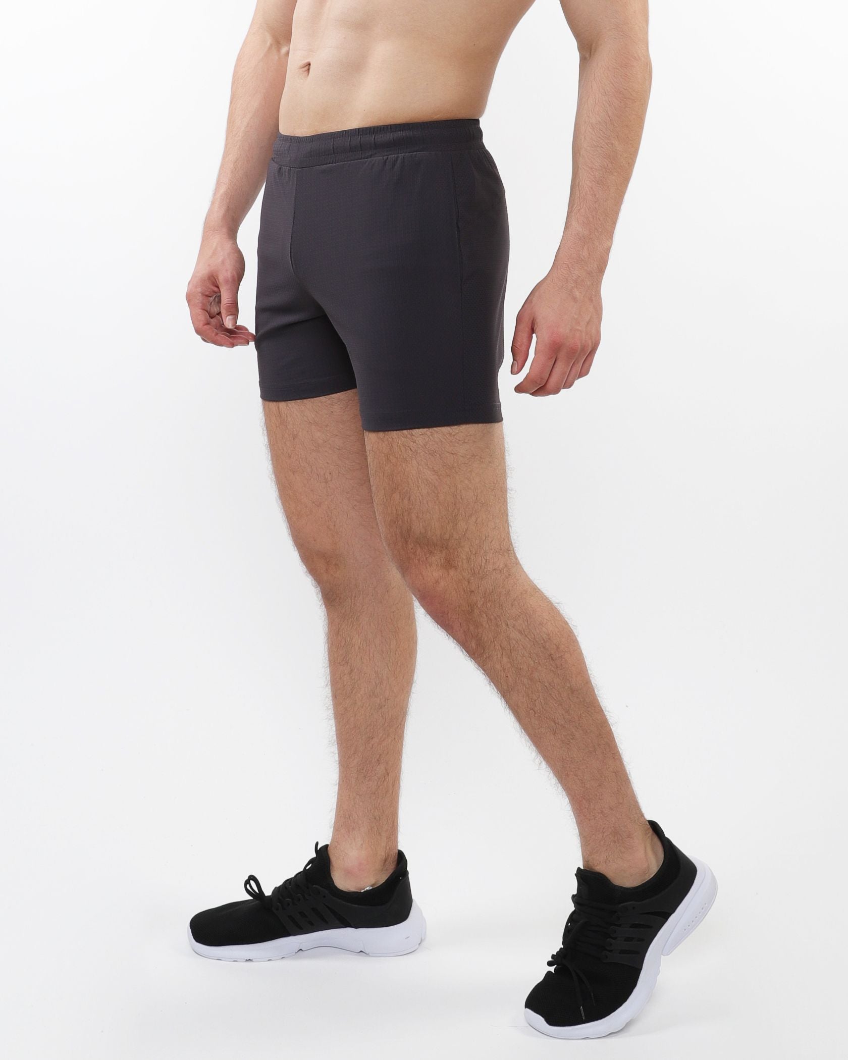 Black textured mesh stretch performance shorts with snug elastic waistband and smooth form fitting fabric