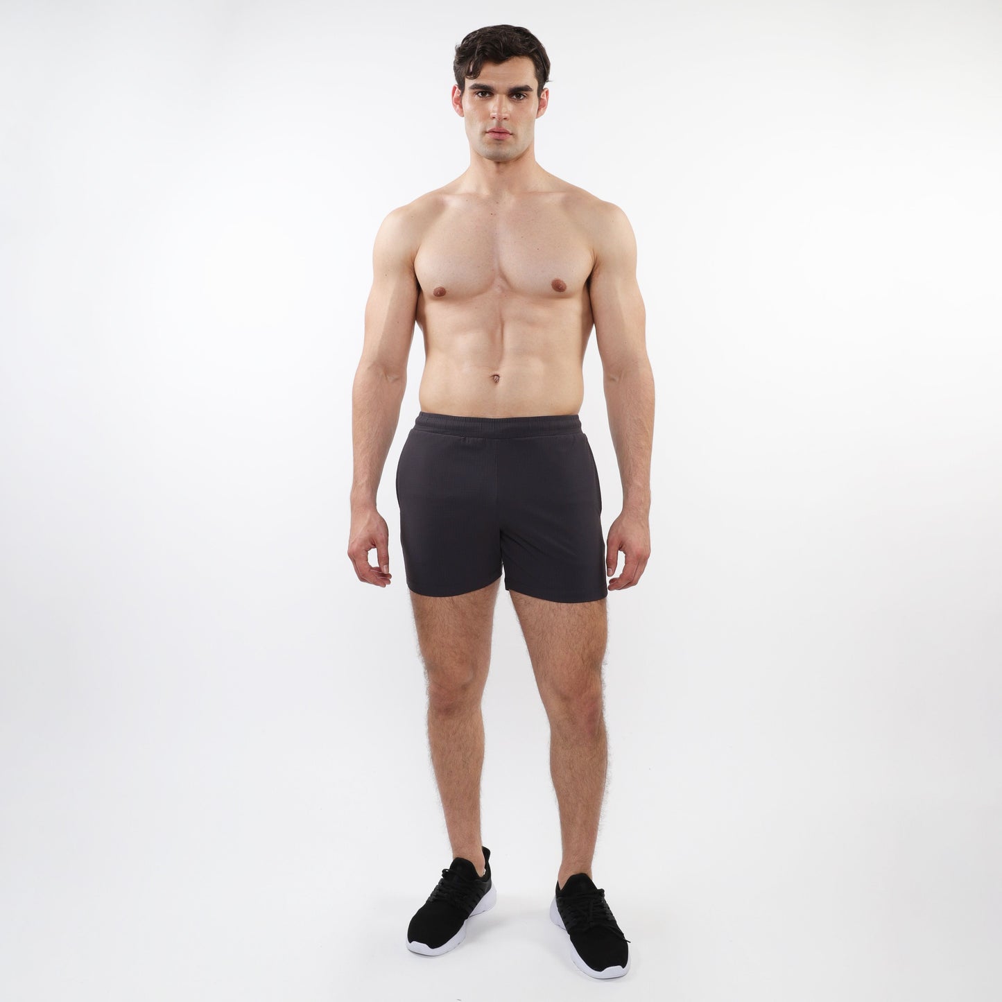 Black textured mesh stretch performance shorts with sleek form-fitting design and elastic waistband for athletic use