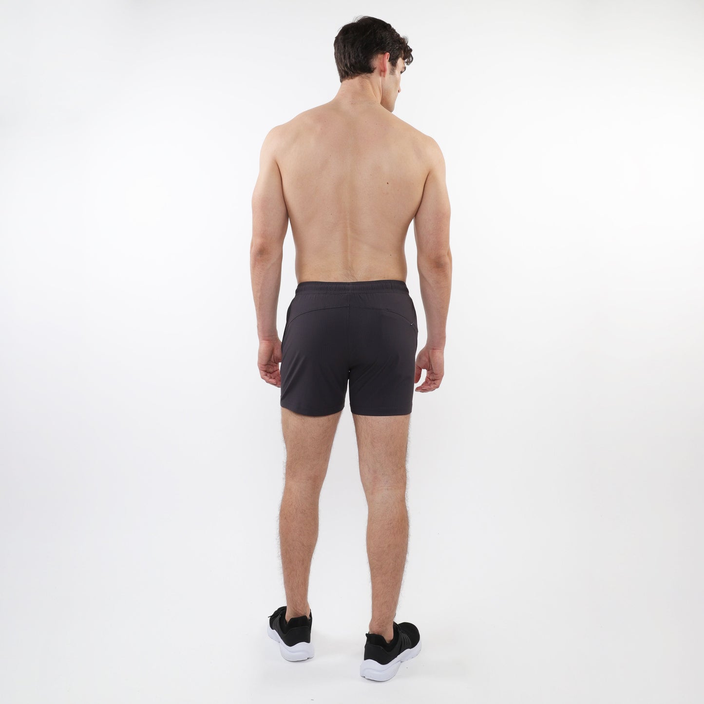 Black textured mesh stretch performance shorts with a sleek form-fitting design and subtle side pockets