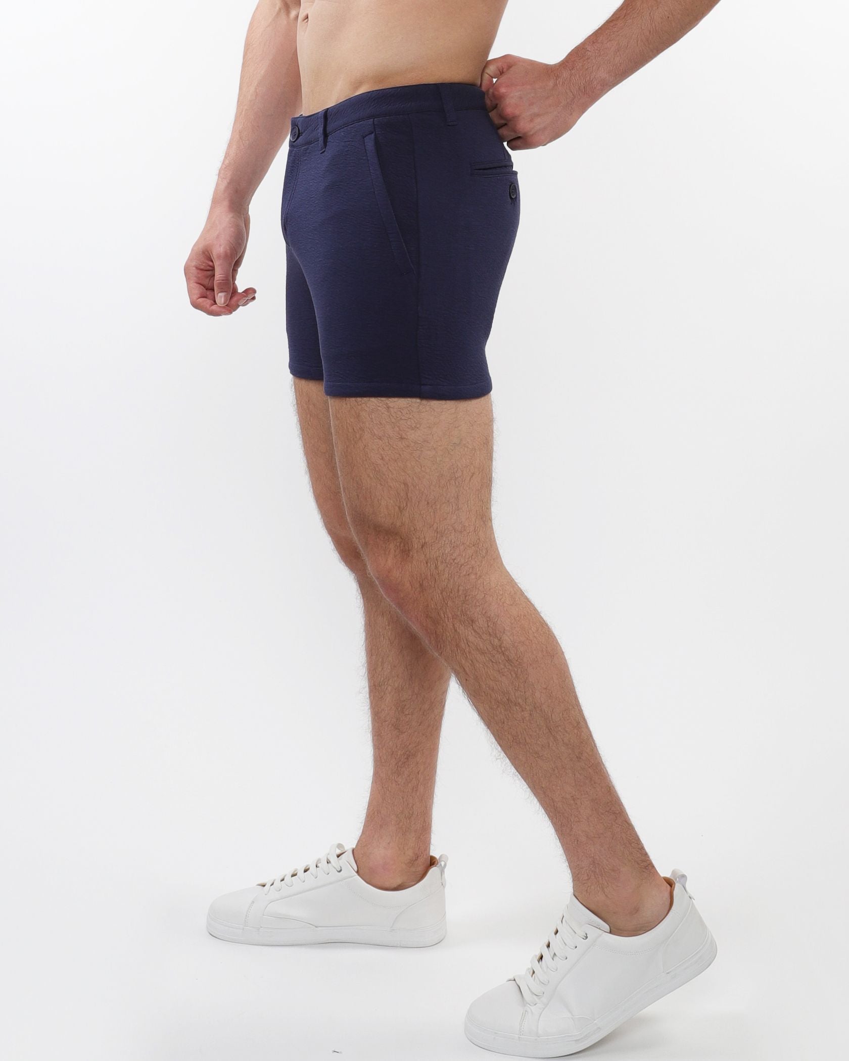 Navy blue textured stretch knit chino shorts for men with sleek tailored fit and subtle zip side pockets