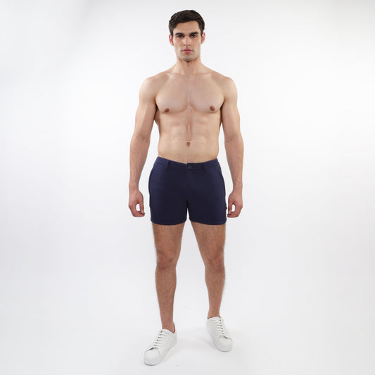 Navy blue textured stretch knit chino shorts with button closure and zip pockets in a clean modern design