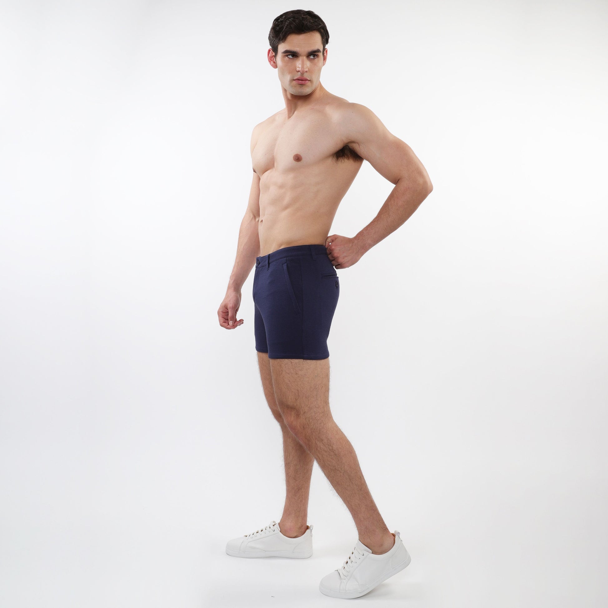 Navy blue men’s briefs with tailored fit and clean design complement textured stretch knit chino shorts with zip pockets