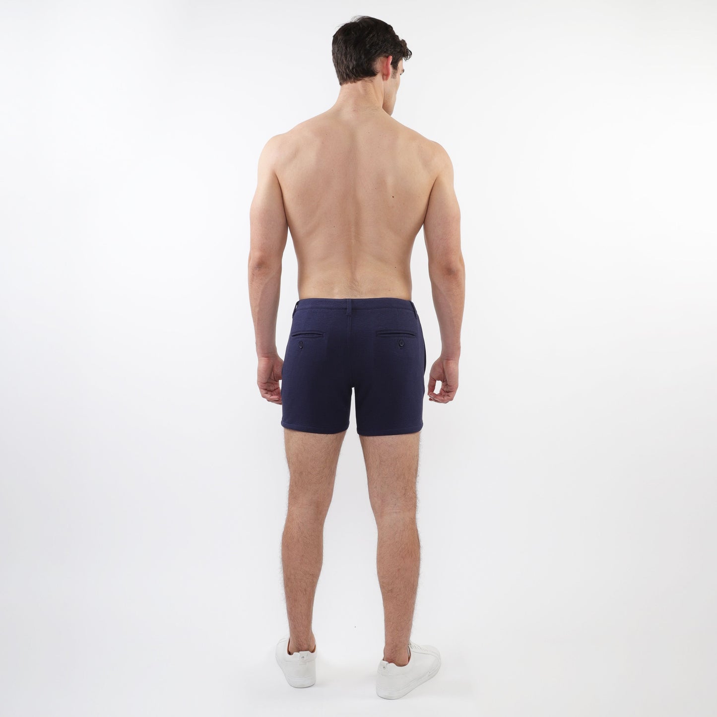 Navy blue textured stretch knit chino shorts with sleek modern design and subtle front zip pockets