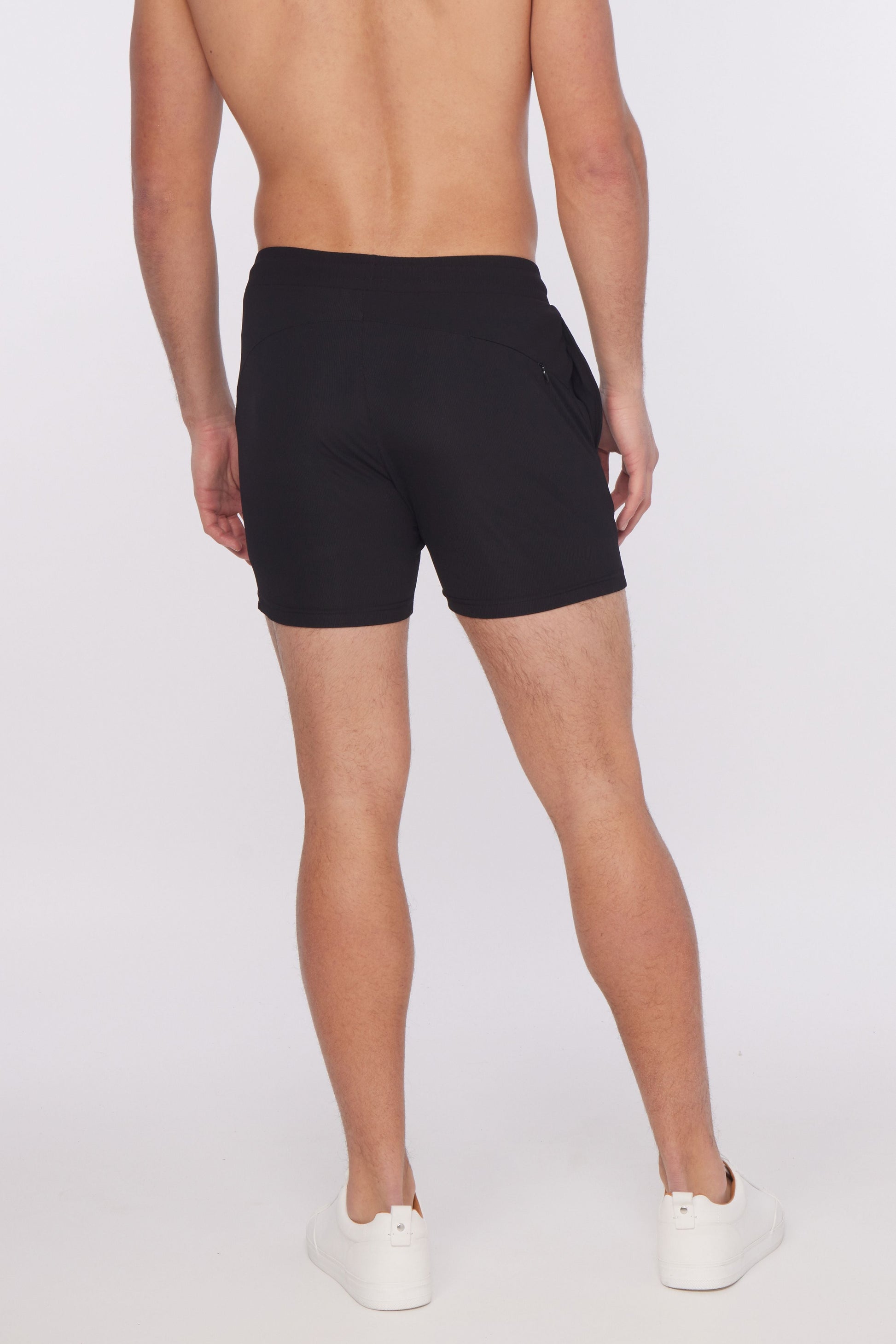 Black textured stretch performance athletic shorts with a sleek modern design and subtle side pockets for active use