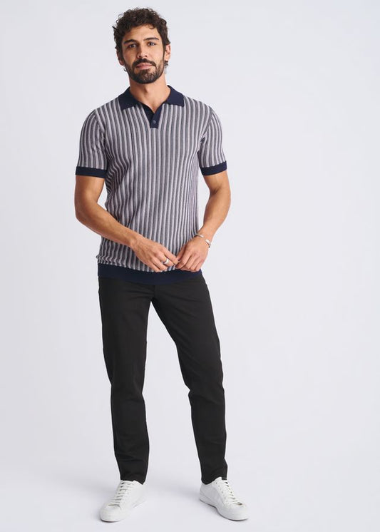 A man wearing a textured stripes silk tencel polo in navy and gray with a dark blue collar and sleeve cuffs