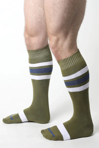 Olive green tight end knee high athletic socks with white and navy horizontal stripes and ribbed cuff and toe design