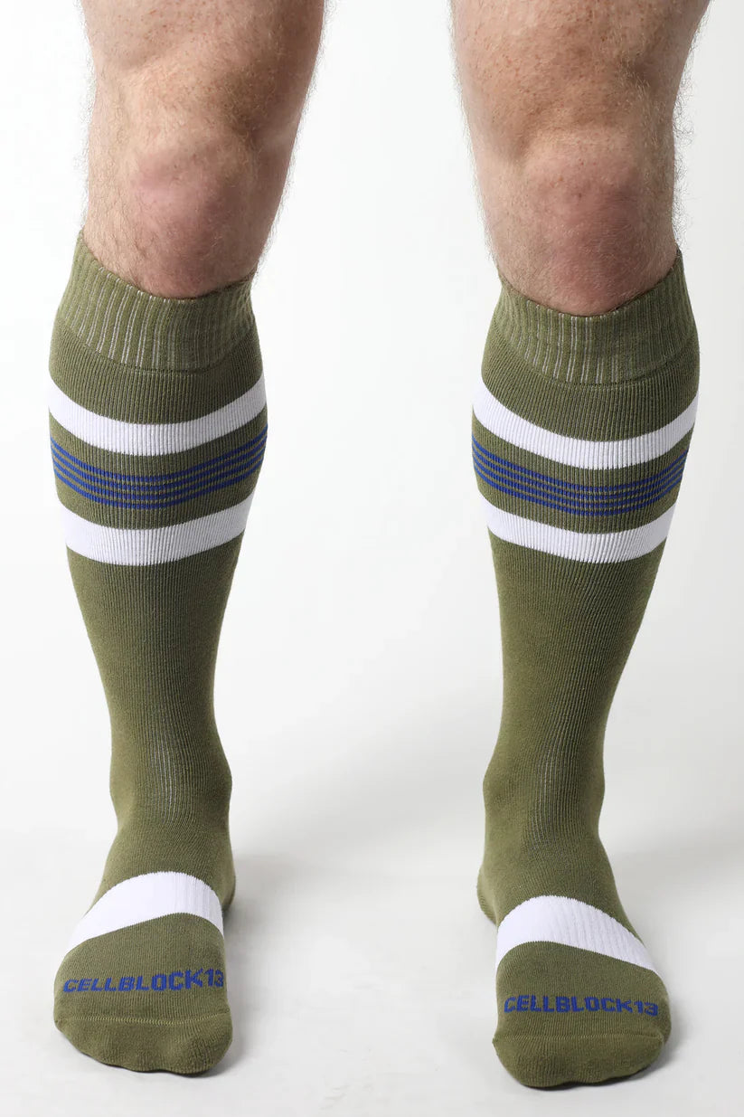 Olive green tight end knee high socks with white and navy stripes ribbed cuff and toe band