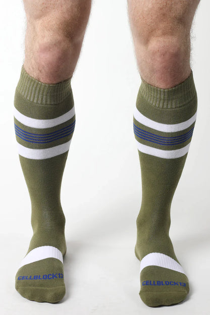Olive green tight end knee high socks with white and navy stripes ribbed cuff and toe band