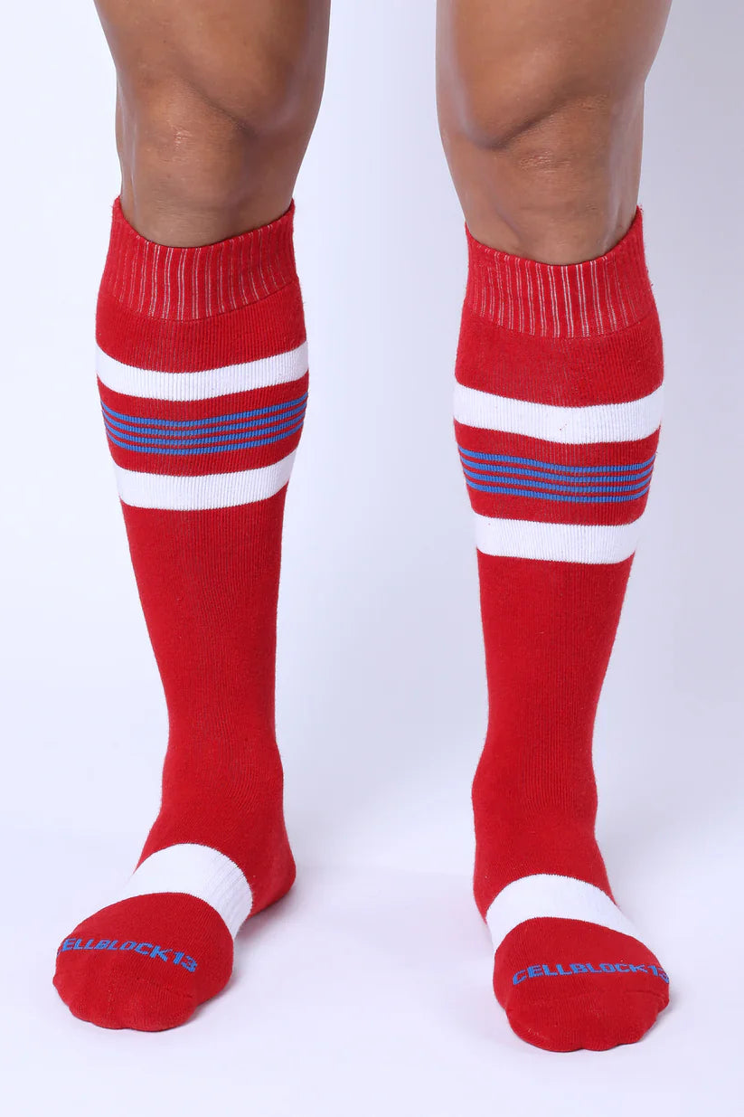 Tight end knee high socks in red with white and blue stripes featuring ribbed cuff and toe band for athletic use