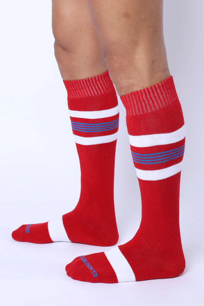 Tight End knee high socks in red with white and navy blue stripes featuring ribbed cuff and toe detailing