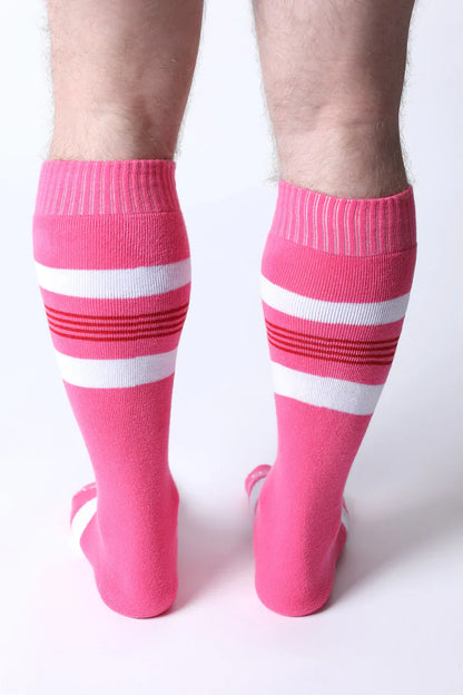 Bright pink tight end knee high socks with white and red striped bands designed for athletic wear