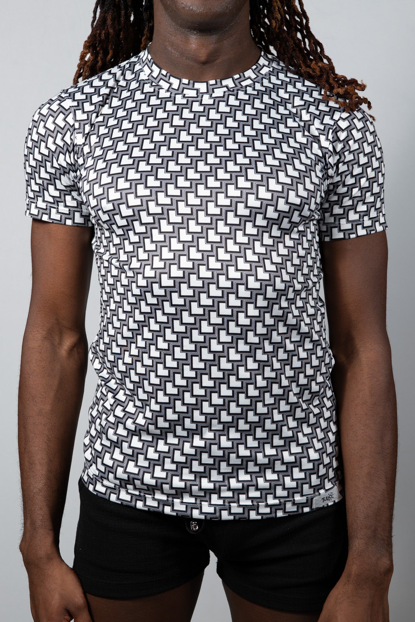 Black and white geometric-patterned short-sleeve rash guard tile print tee for sun protection and water sports