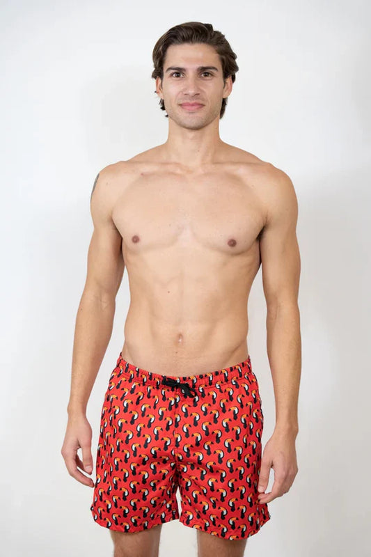 Toucan print swim short featuring red swim trunks with a black and yellow abstract pattern for beachwear
