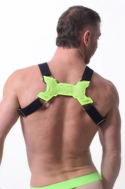 Neon green x-shaped back support with black straps on the back side of transistor harness for posture correction