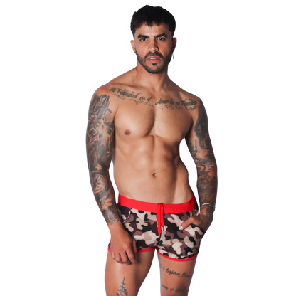 Men's camo print beach shorts featuring a bold red elastic waistband, matching red trim, and a drawstring front.