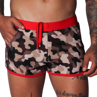 Men's camo beach shorts with red trim, drawstring waistband, and side pockets in a short athletic fit.