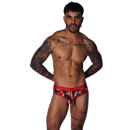 Men's low-rise swim brief in camo print with red waistband, cutouts, and a front drawstring tie.