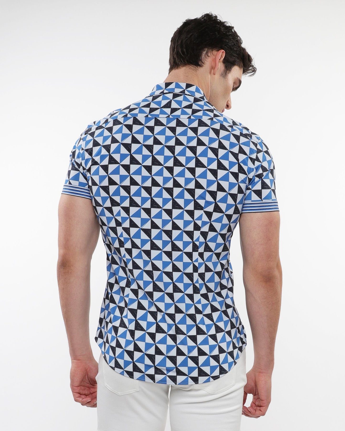 A man wearing a triangles printed performance short-sleeved shirt with blue black and white geometric pattern