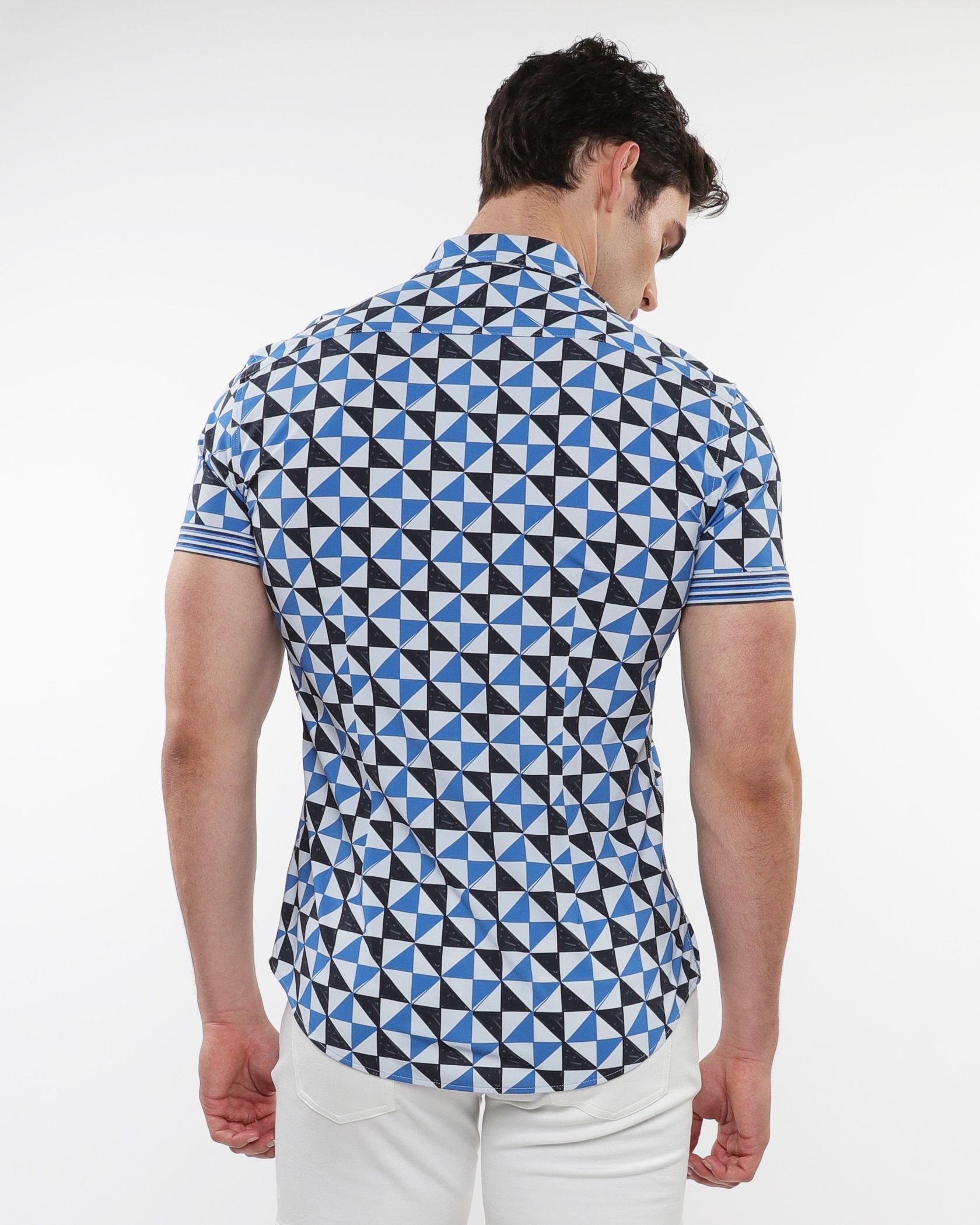 A man wearing a triangles printed performance short-sleeved shirt with blue black and white geometric pattern