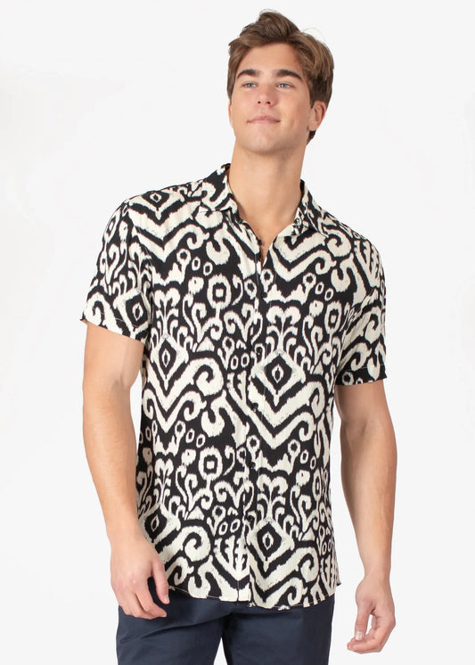 Black and white short-sleeved button-up tribal abstract s slash s shirt with intricate ikat design pattern