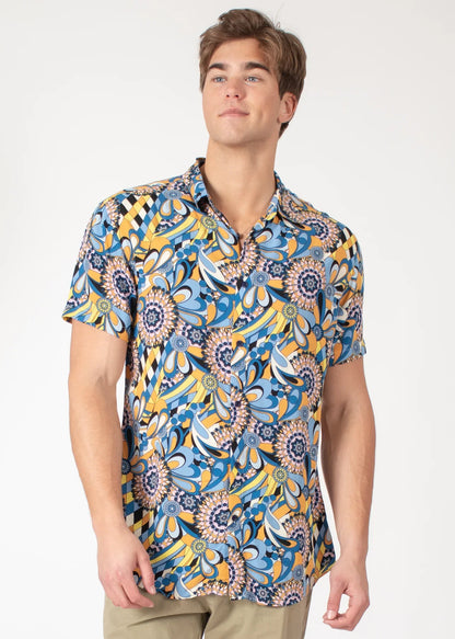 A vibrant blue and yellow floral-patterned tropical abstract short-sleeve button-up shirt with a classic collar