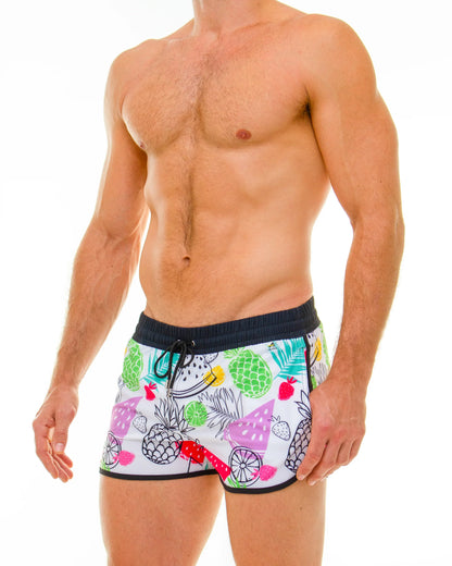 White tropical fruit swim shorts featuring colorful pineapples watermelon and strawberries pattern for beachwear