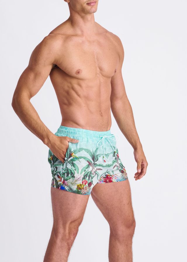 Light blue tropics print swim shorts with mesh lining featuring green leaves red flowers and colorful birds