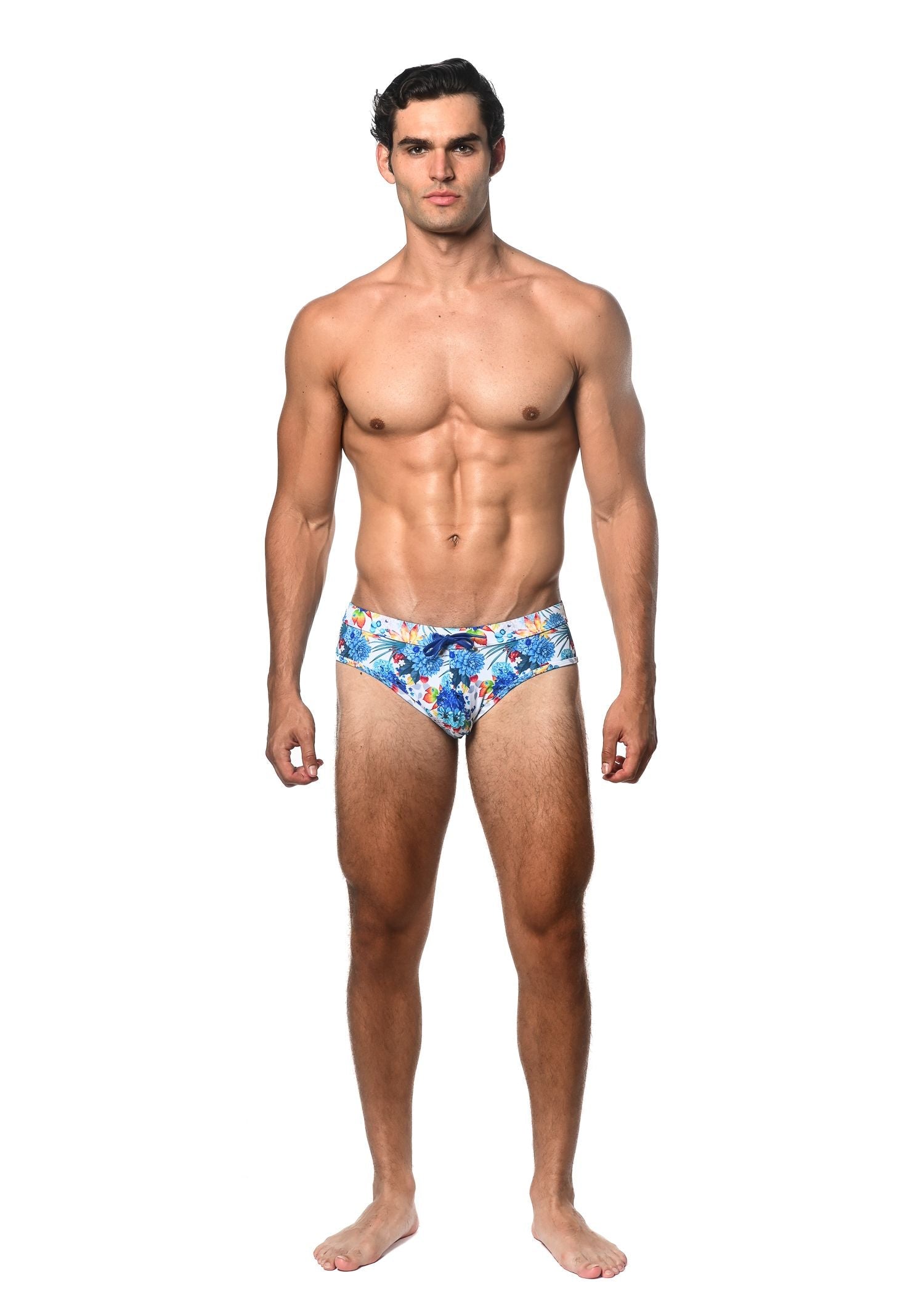 Men’s blue tropics printed swim brief with vibrant red and yellow floral pattern for stylish beachwear