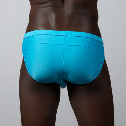 Tulio bikini brief solid bright turquoise swim trunks with subtle circular pattern and sleek form-fitting design