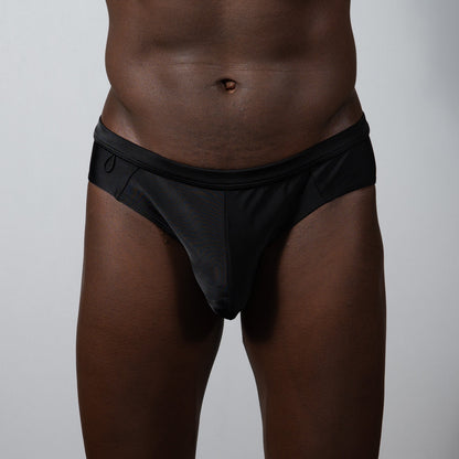 Tulio bikini brief solid black sleek form-fitting swim trunks with smooth fabric finish for swimming and sunbathing