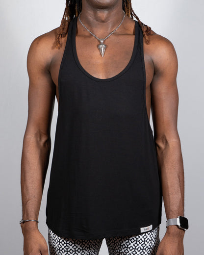 Black tulio racerback tank top with minimalist design and small brand tag at bottom hem in 4 colors available