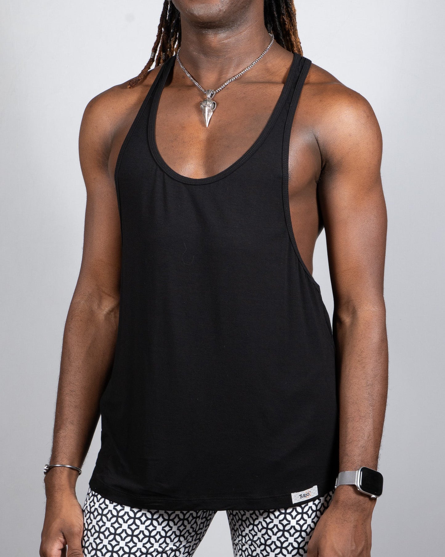 Black tulio racerback tank top with minimalist design showing the back side in a comfortable lightweight fabric