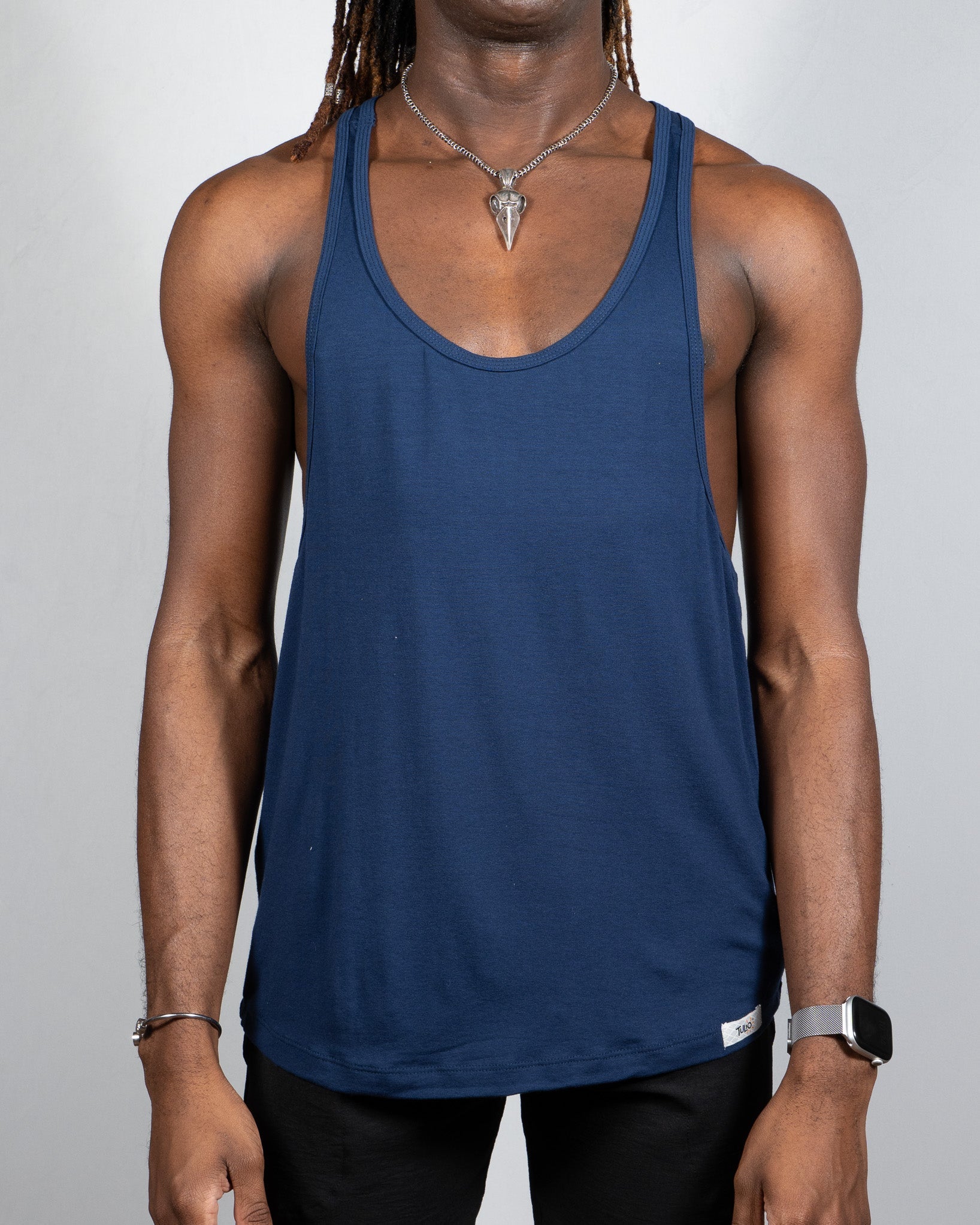 Navy blue sleeveless tulio racerback tank made from breathable fabric shown from the back side in four colors available