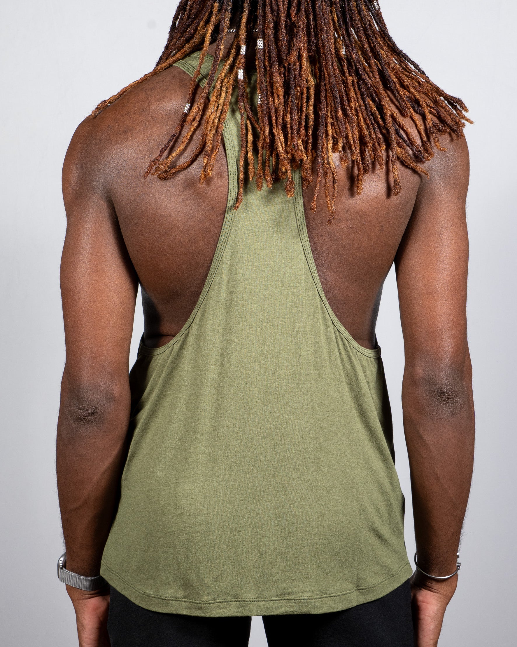 Olive green tulio racerback tank top with relaxed fit and subtle ribbed texture shown from the back side