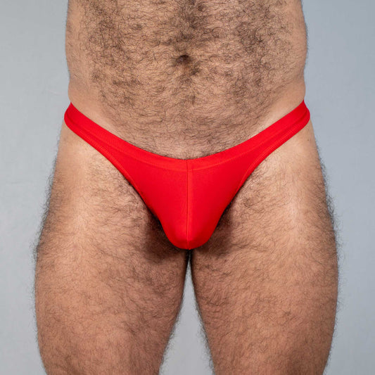 Bright red Tulio swim thong made of smooth stretchy fabric with a form-fitting design shown from the back side