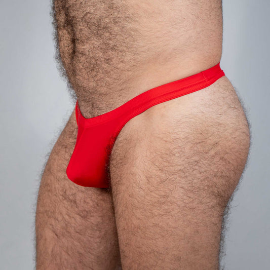 Red tulio swim thong made of smooth stretchy fabric shown from the back in a solid color design