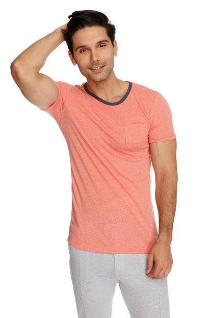Coral short-sleeved t-shirt with dark gray ribbed crew neckline and chest pocket paired with heather grey tactical urban yoga pants
