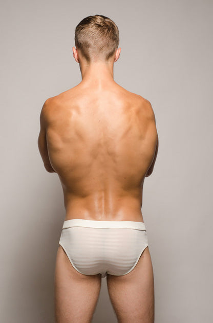 Back view of a man wearing white striped tartarus buckle brief underwear with a secure buckle design
