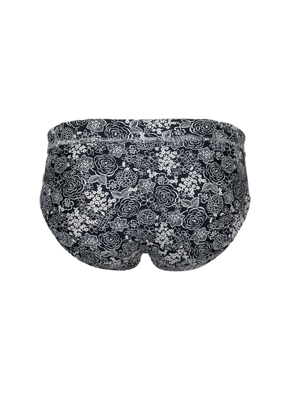 Black tartarus swim brief with delicate white and gray rose floral pattern designed for swimwear use