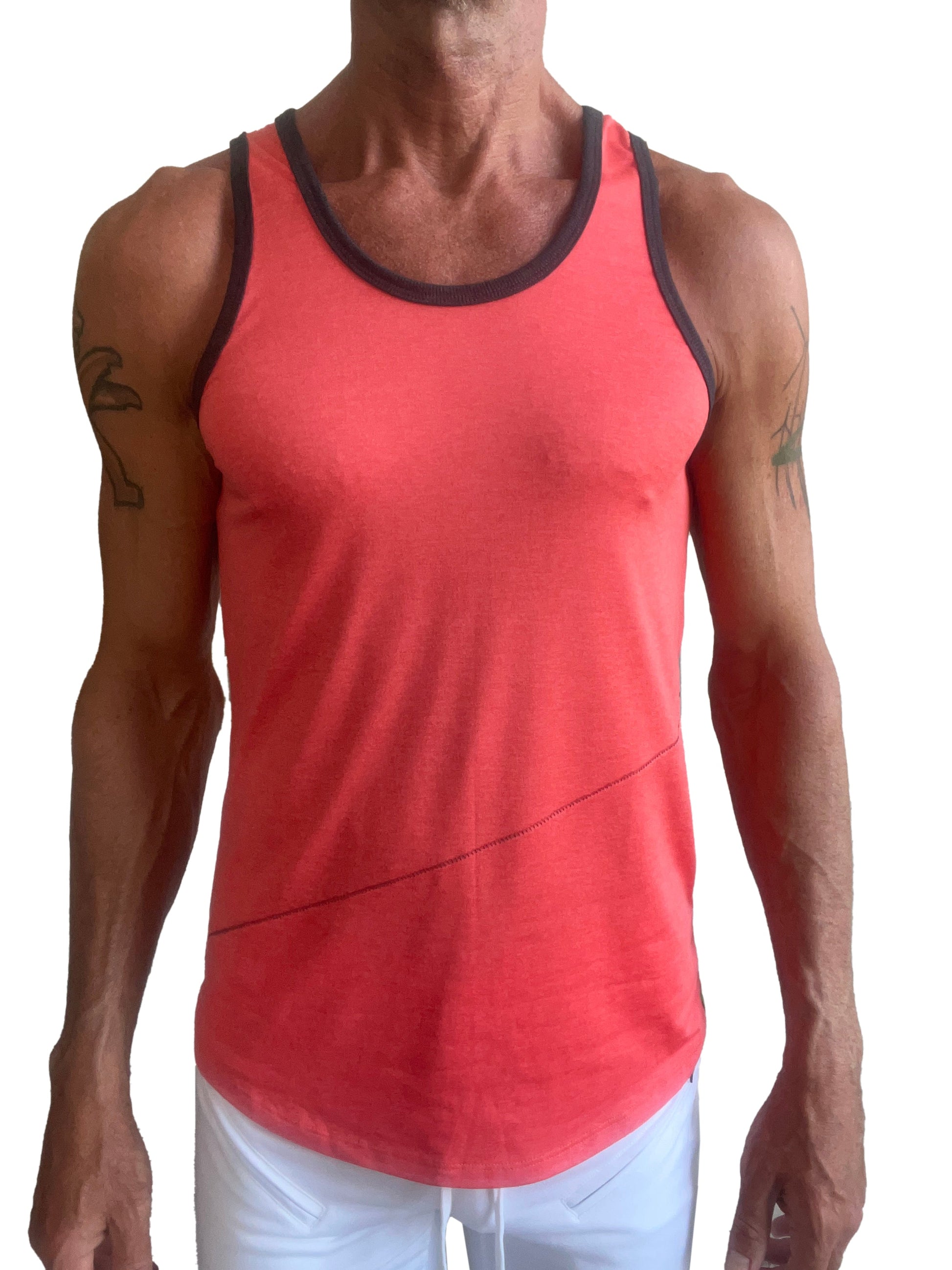 A coral-colored tank top with black trim and subtle diagonal seam detail called the perfect tank coral