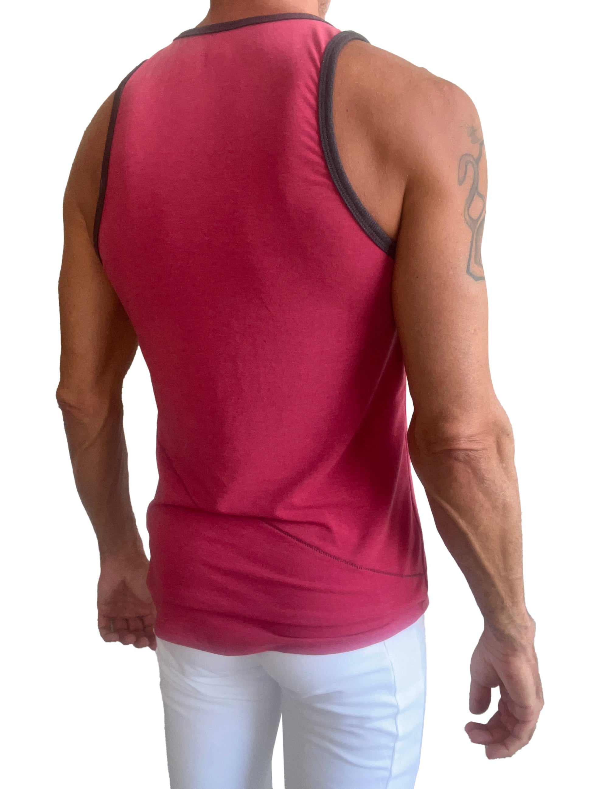 A vibrant red sleeveless tank top with black trim along the neckline and armholes called the perfect tank raspberry