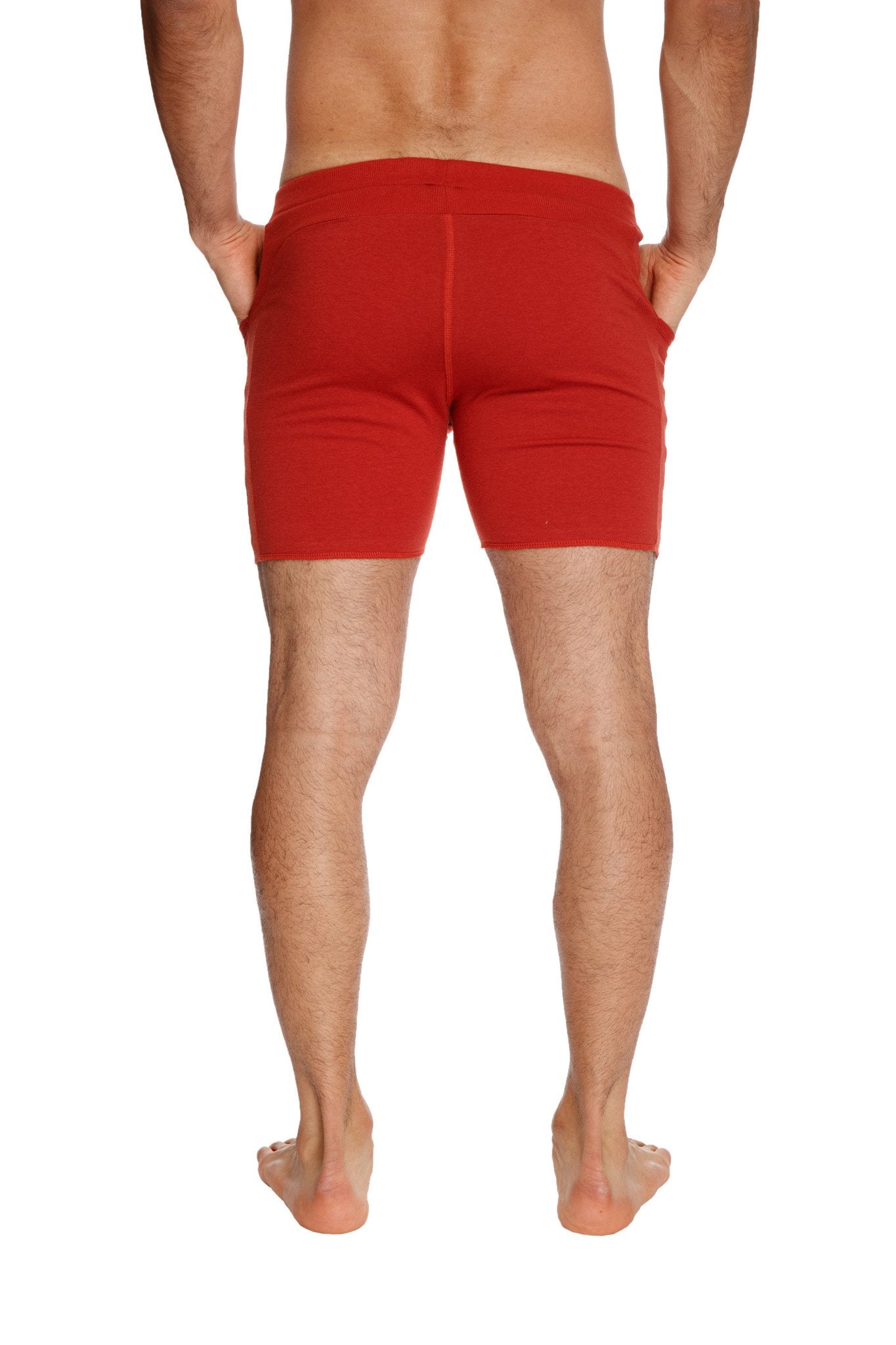 Transition yoga short in cinnabar red featuring snug fit and side pockets for athletic use