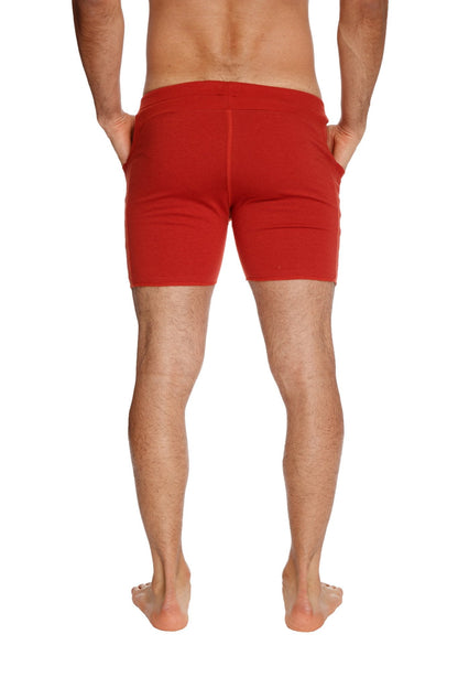 Transition yoga short in cinnabar red featuring snug fit and side pockets for athletic use