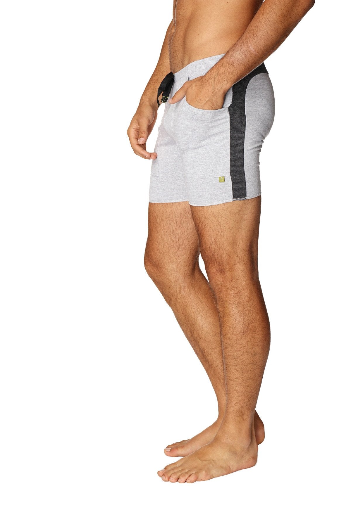 Gray transition yoga shorts with black side stripe and small green logo on lower leg for athletic use