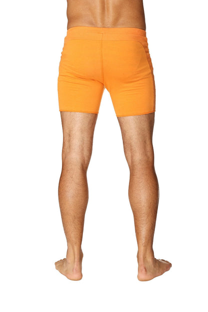 Bright orange transition yoga short with form-fitting smooth fabric finish designed for athletic wear