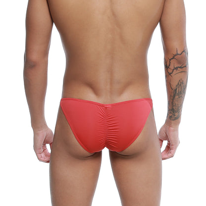 Red form-fitting u-station me bikini swim trunks with ruched back design shown from the back side
