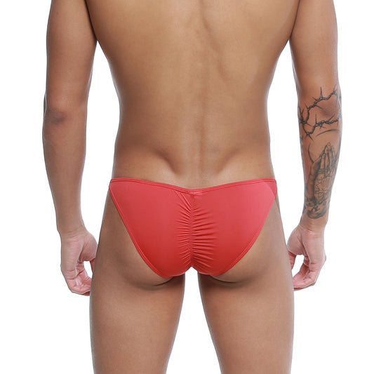 Red form-fitting u-station me bikini swim trunks with ruched back design shown from the back side